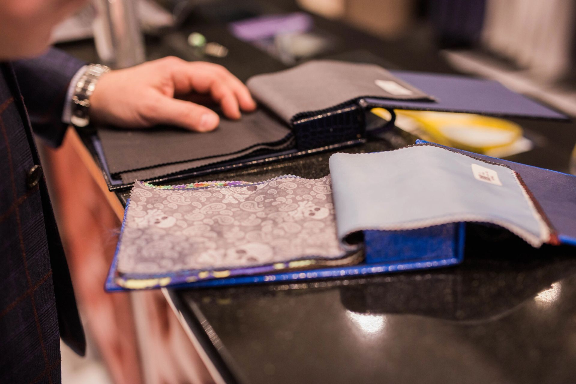 Hands turning through a fabric swatch book