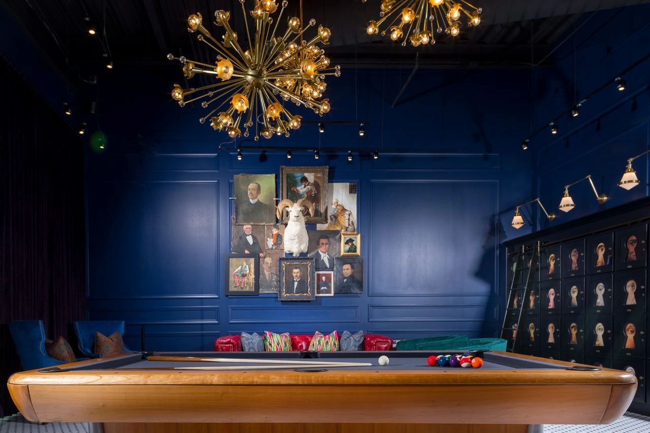 H Club Rogers lounge with billiards table and navy walls