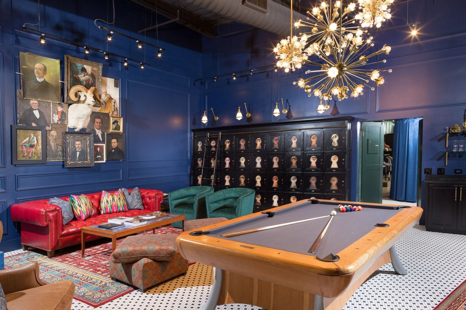 H Club Rogers private lounge with a billiards table, navy walls, members' lockers and a chandelier